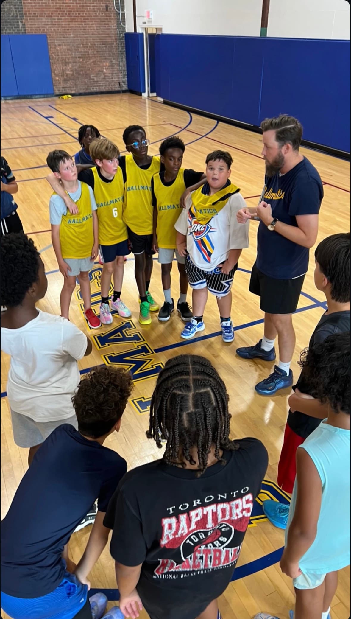 Coach Nolan huddling with Ballmatics players