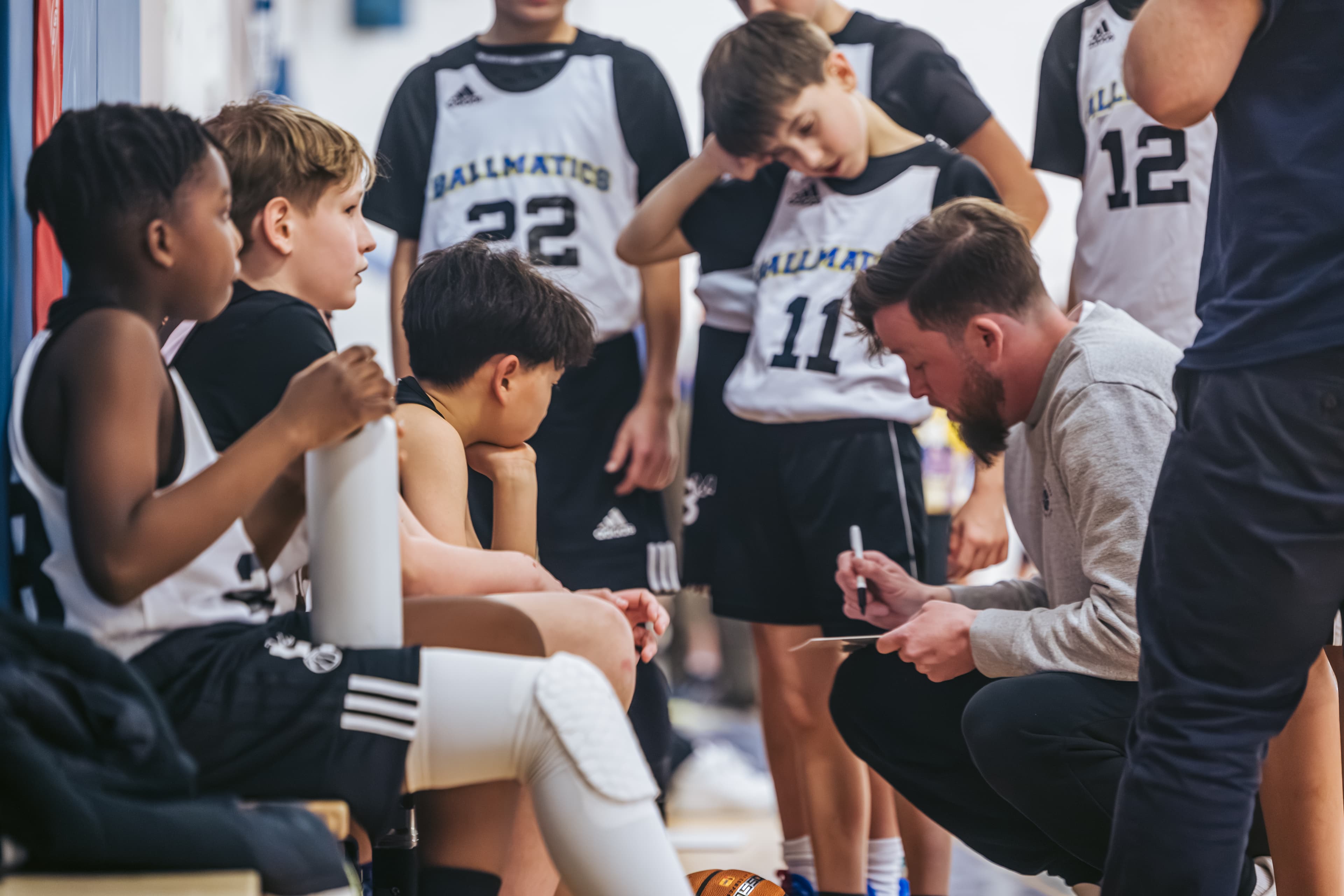 Coach Nolan drawing up a play during a timeout